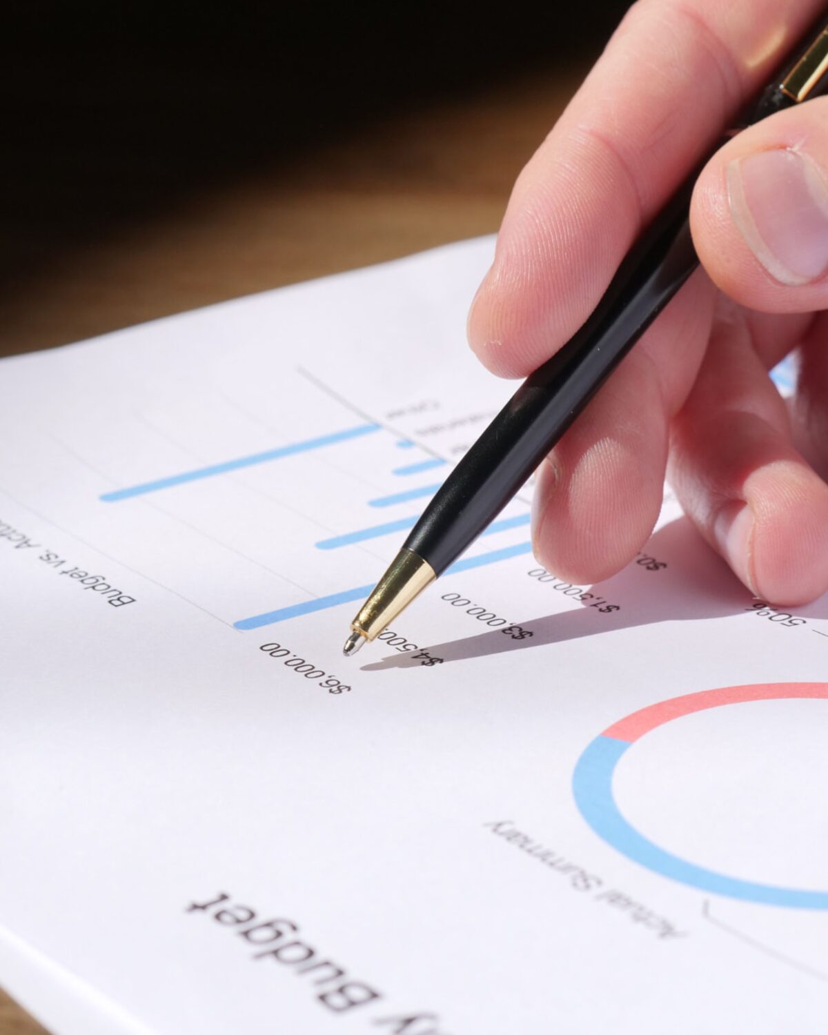 An owner and their CFO reviewing a one-page report at a kitchen table.